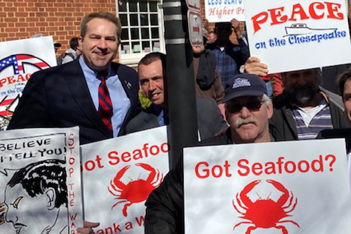 Johnny at a watermen's rally with 'Got Seafood?' signs
